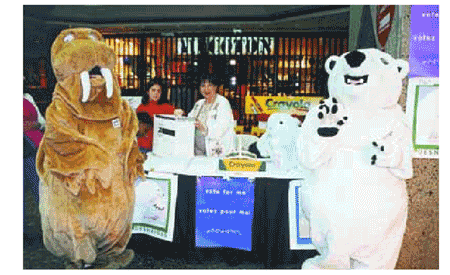 This photo shows mascots serving as candidates, and Elections Canadas Community Relations Officer Denise McCulloch during an election simulation for families who visited a Montral shopping centre last Easter.