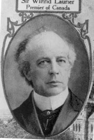 Black-and-white portrait of Sir Wilfrid Laurier's face shown in an oval on a postcard.