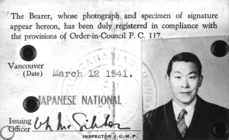 Black-and-white photo of an internment identification card of a Canadian citizen of Japanese origin in 1941. His photo appears on the right-hand side of the card.